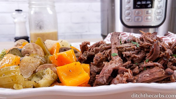 A plate of food with stew, with Pot roast and Beef