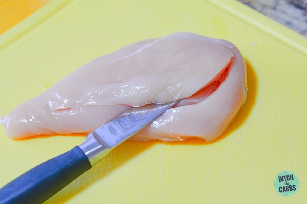 chicken being cut with a small knife