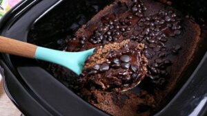 Chocolate lava cake being served with a blue spoon