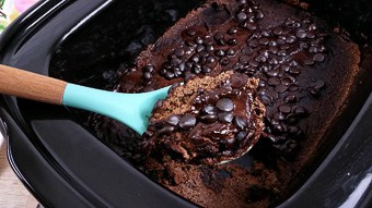 Chocolate lava cake being served with a blue spoon