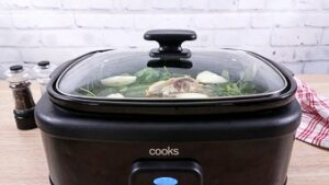 Slow cooker with bone broth slowly cooking