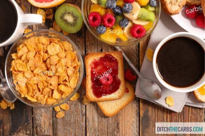 A tray of food on a wooden table with toast jam sugar and breakfast cereal