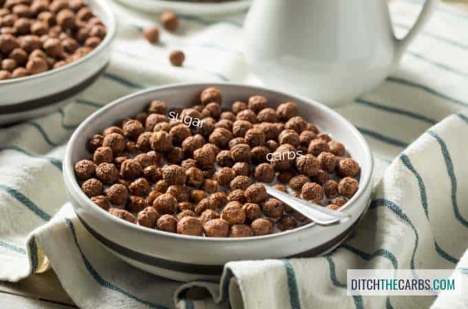 A bowl of chocolate breakfast cereal with a spoon