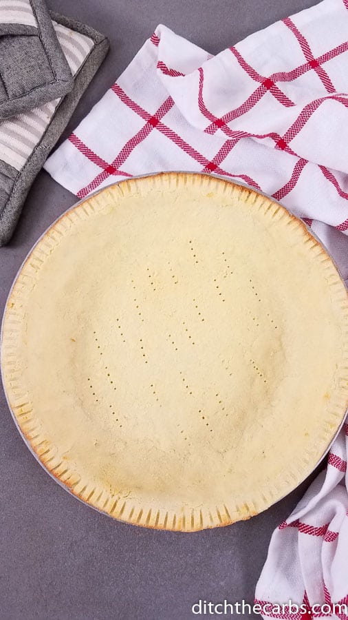 Baked coconut flour pie crust on a red cloth