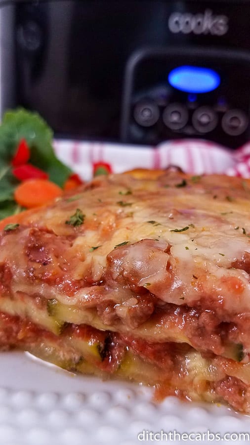 Slow cooker lasagne served on a plate in front of the instant pot