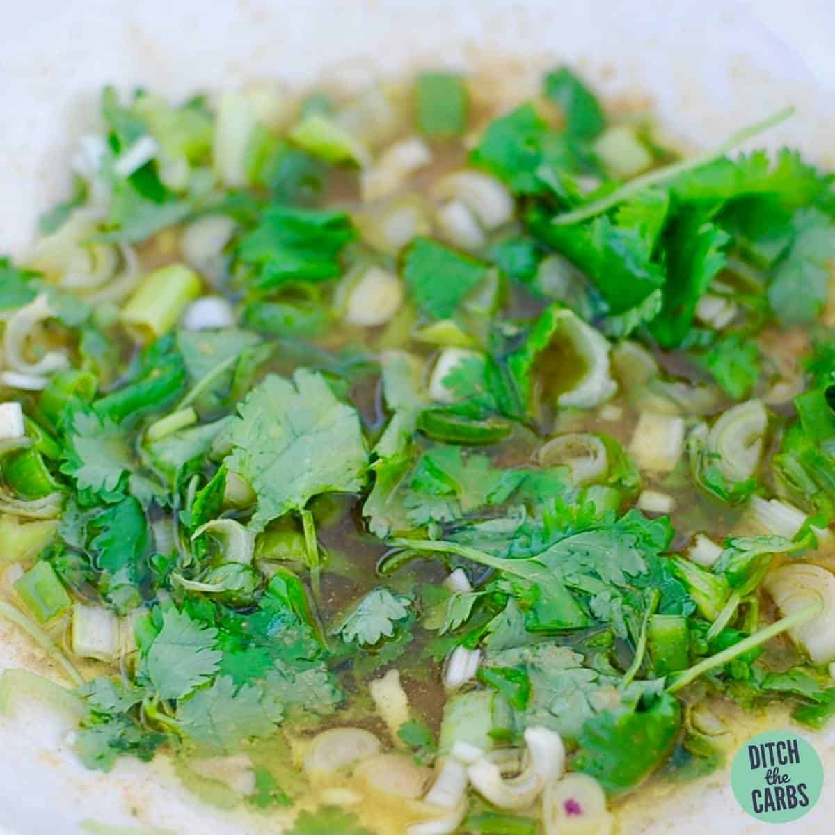 close up of lime dressing with fresh cilantro
