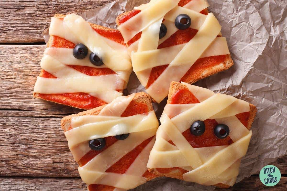 pizza squares decorated to look like spooky mummies