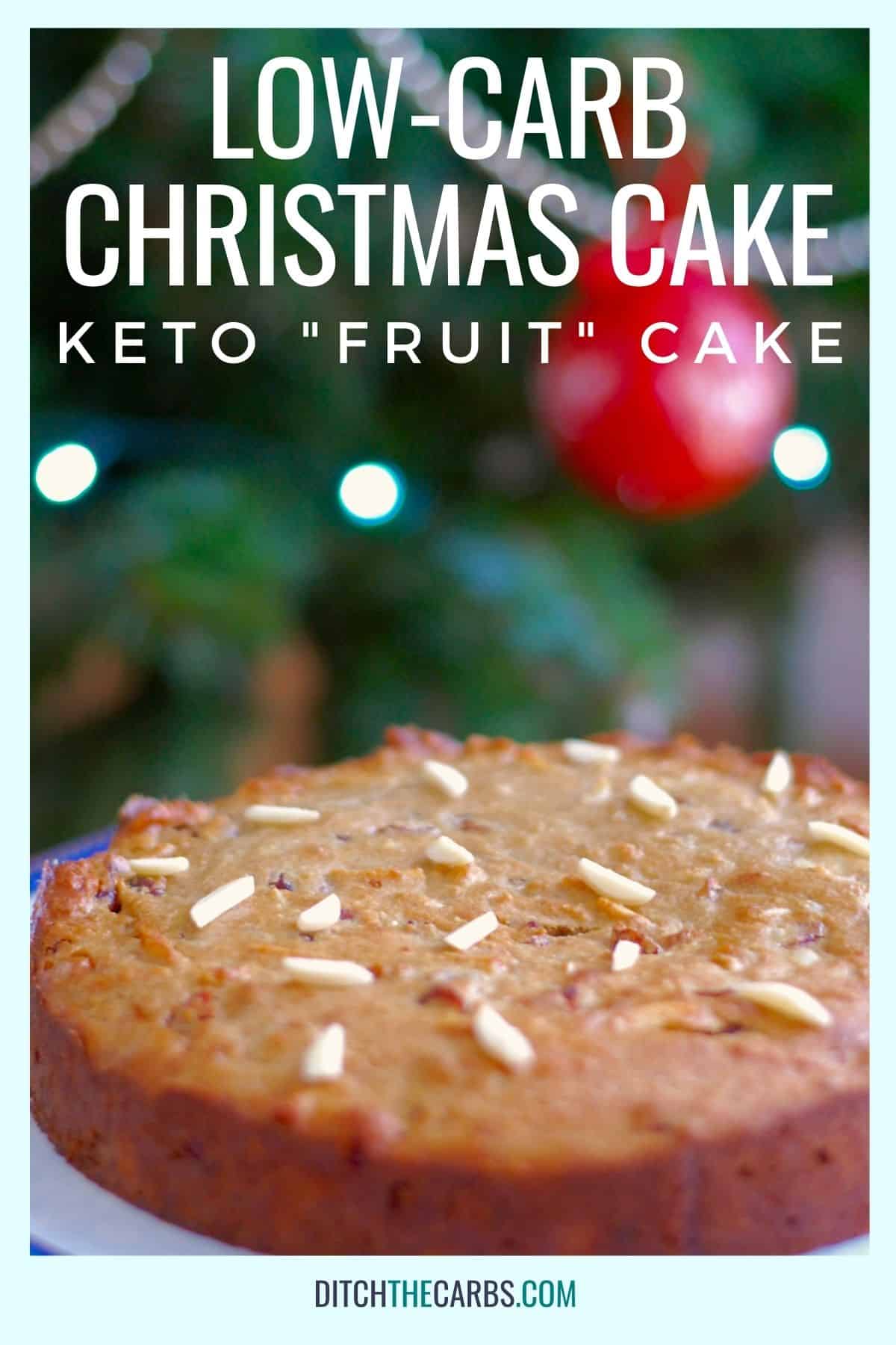low-carb Christmas cake sitting in front of a Christmas tree
