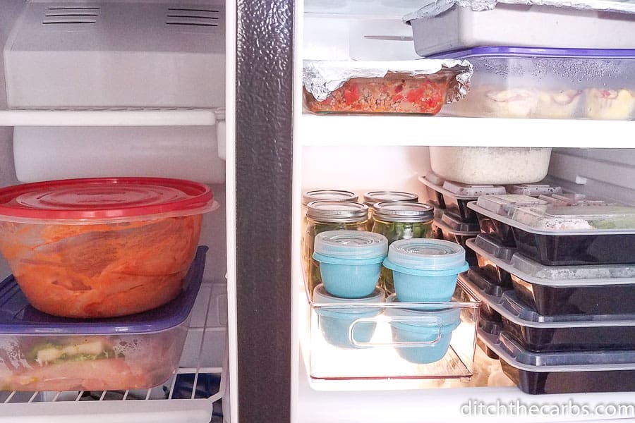 An open refrigerator filled with food ready for meal prep