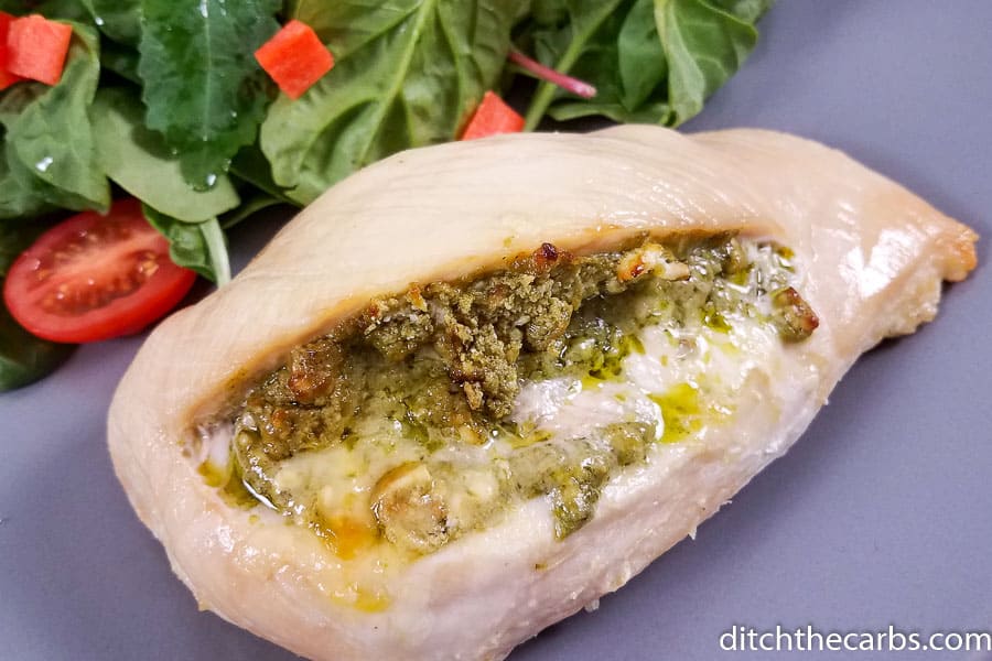Chicken breast stuffed with cream cheese and pesto served with salad