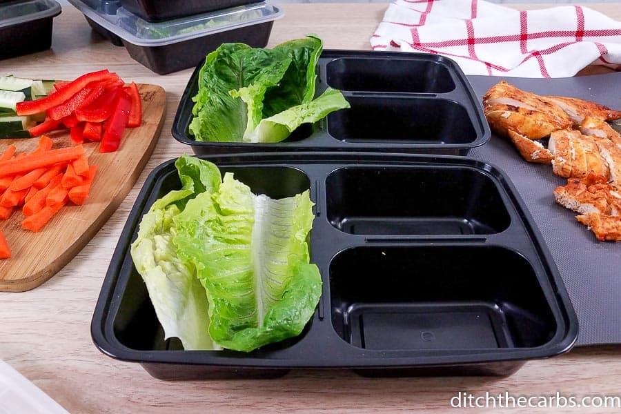 Meal prep containers with salad and each one