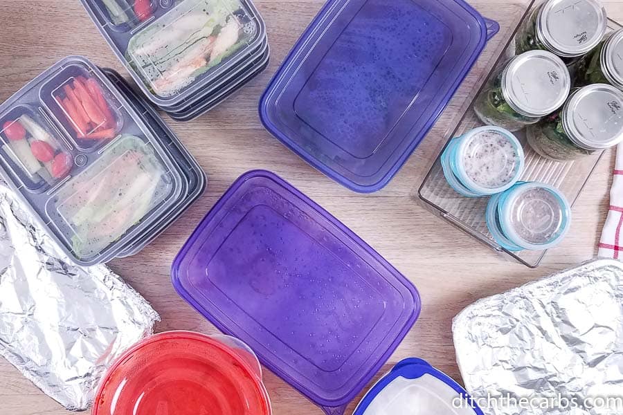 A plastic containers filled with different types of food on a table 