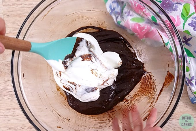 Folding whipped egg whites into the chocolate batter