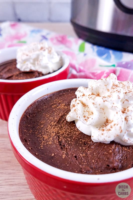 Sugarfree chocolate mousse served with whipped cream and sprinkled with cocoa powder