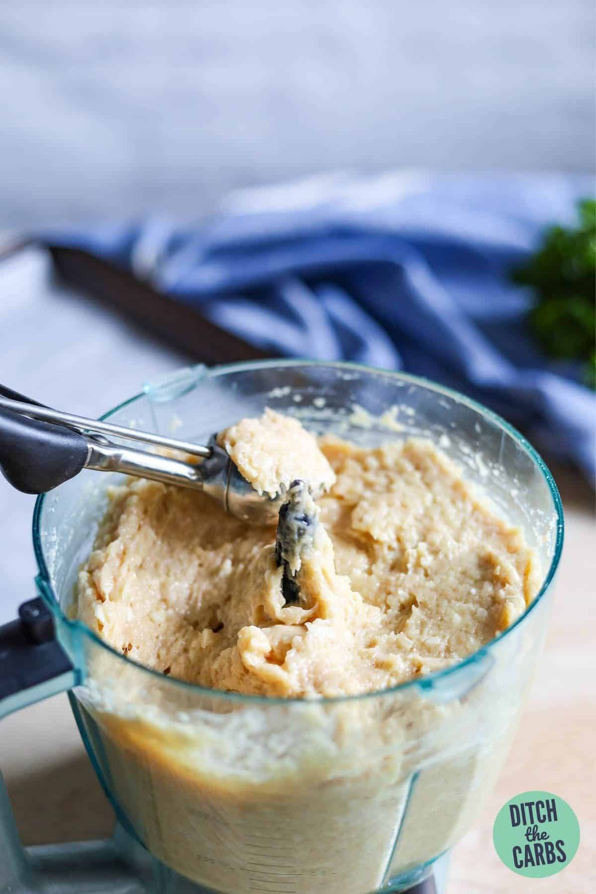 scooping the cheesy chicken meatball mixture high-protein low-carb (HPLC)
