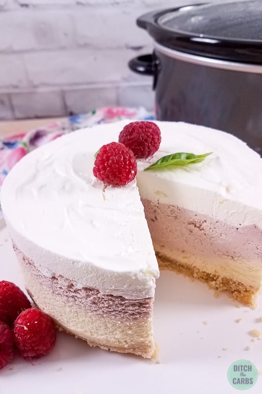 Slow cooker vanilla berry cheesecake served with berries and an instant pot in the background