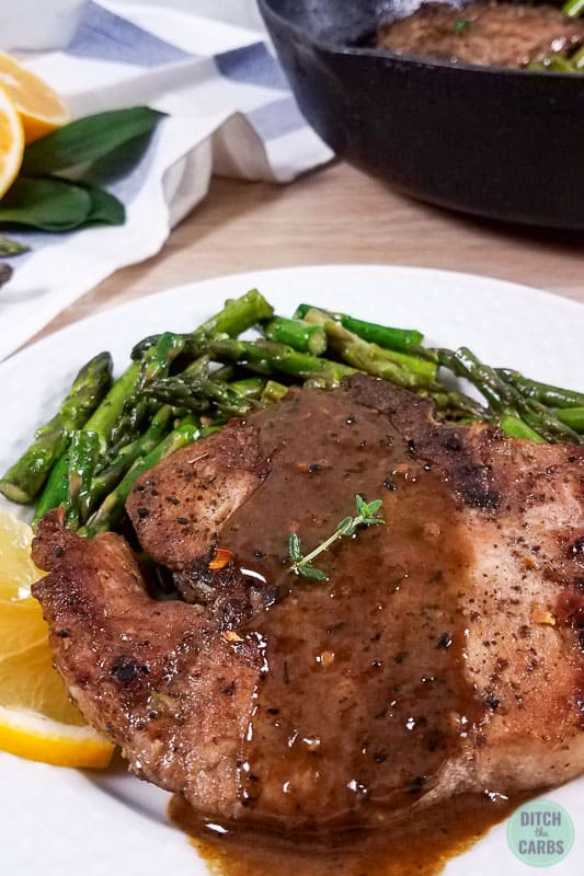 pork chop recipe served with garlic butter and served with fresh  herbs