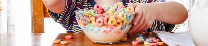 child eating bowl of coloured cereal and milk