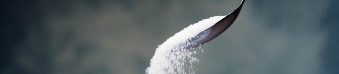 reduce sugar from your child's diet showing sugar falling from a spoon