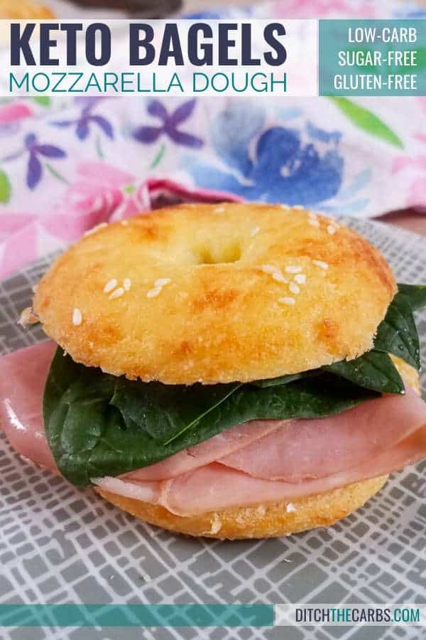 Baked mozzarella dough bagel sliced and filled with salad and ham