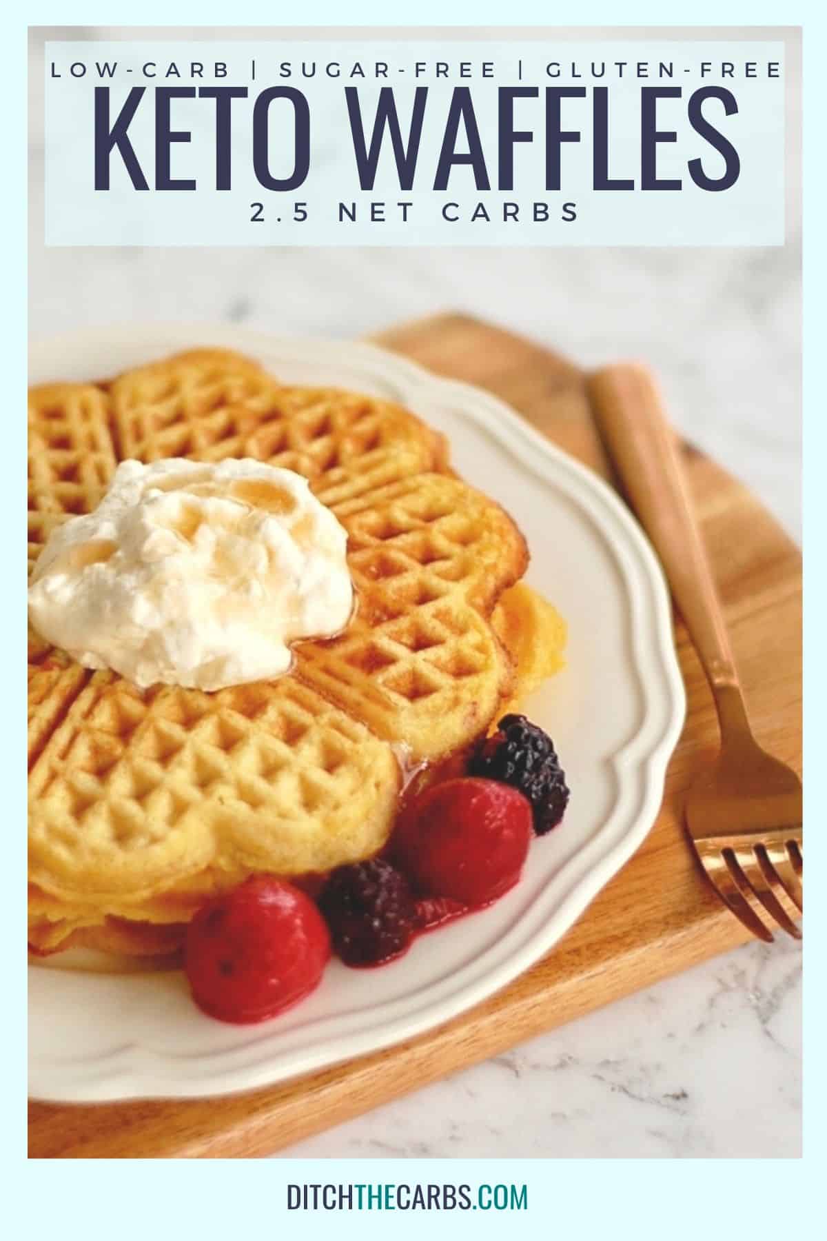 crispy sweet keto waffles with fresh berries and powdered sweetener on a white fluted plate