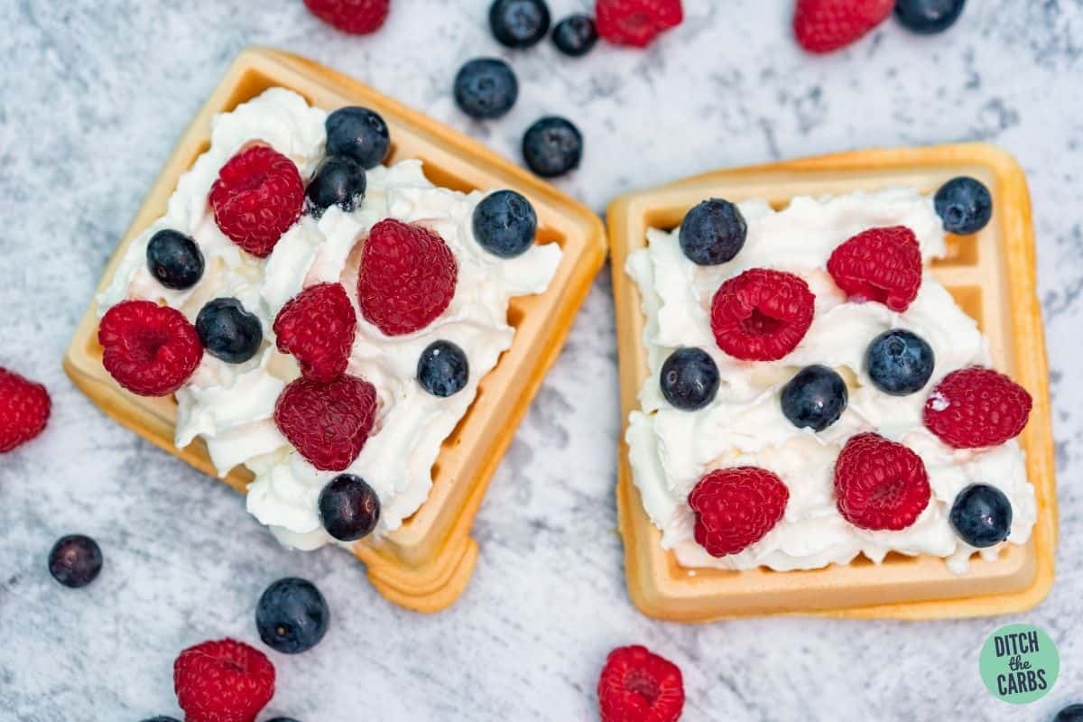 waffles served with whipped cream and fresh berries