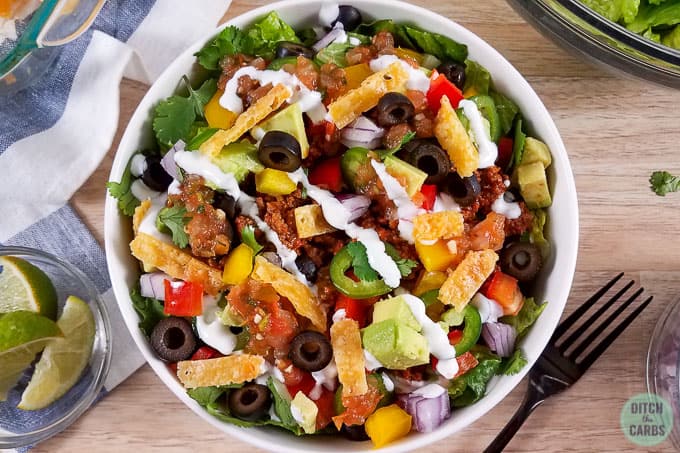 A bowl of taco salad on a plate 
