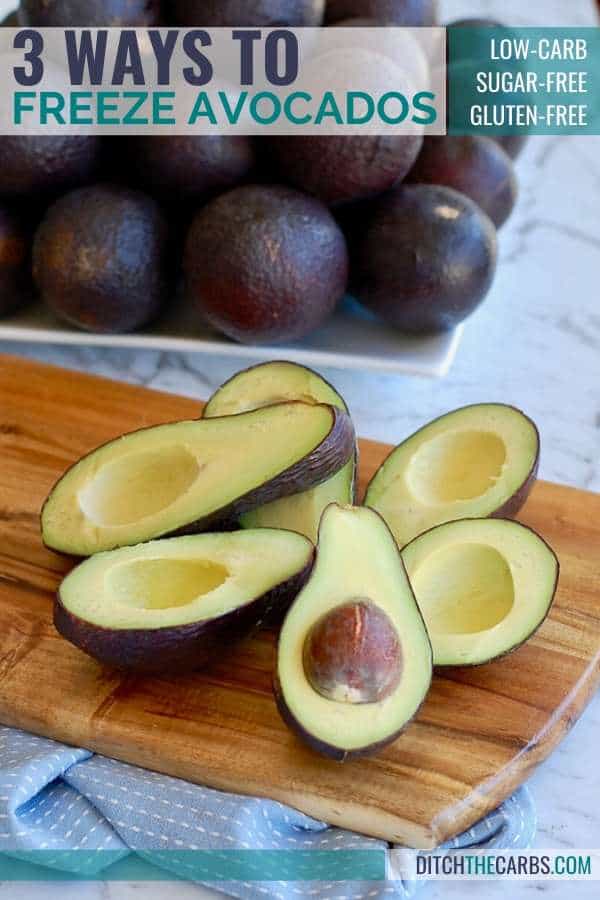 halved avocados on a wooden board