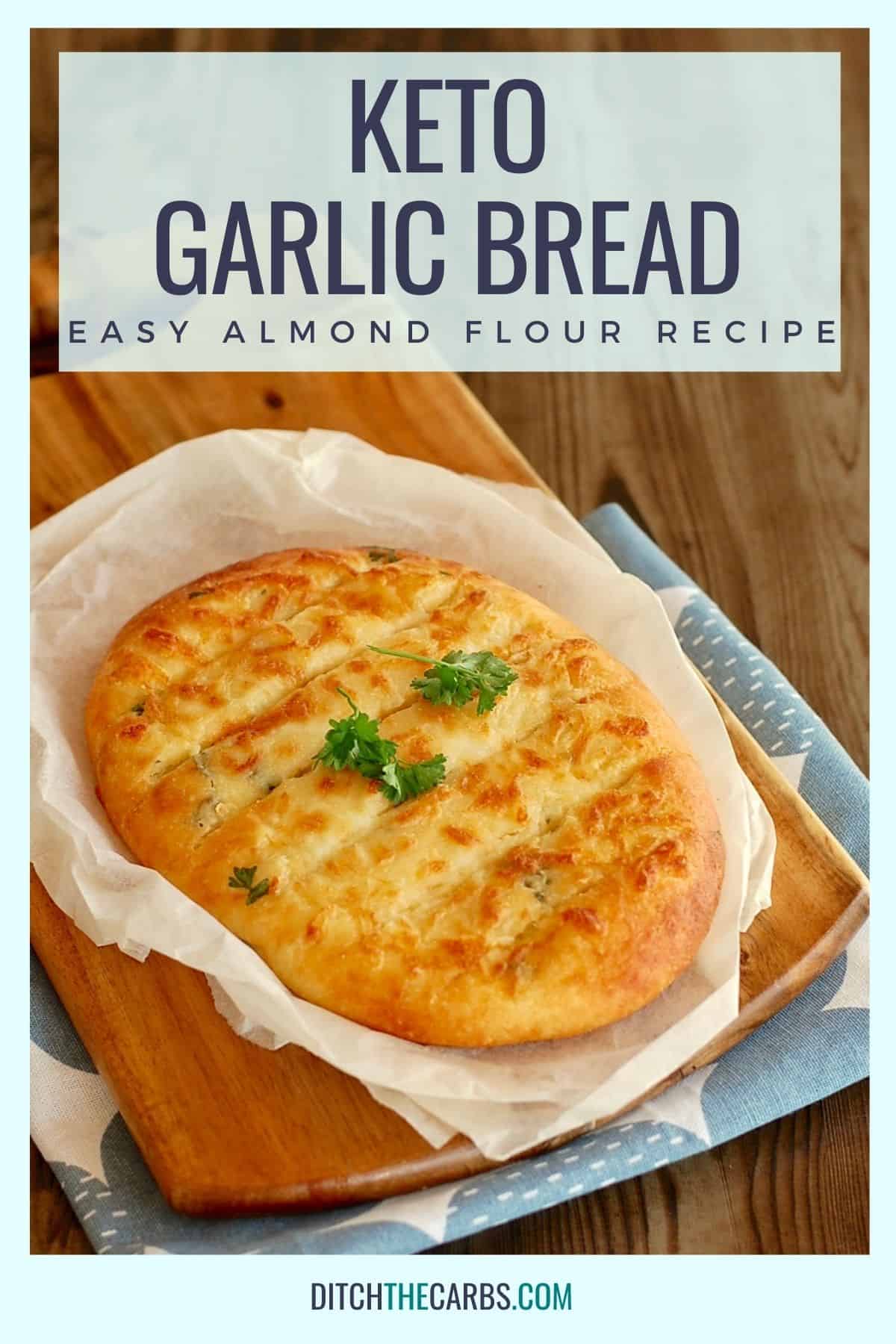 cheesy keto garlic bread sliced on baking parchment and a bread board