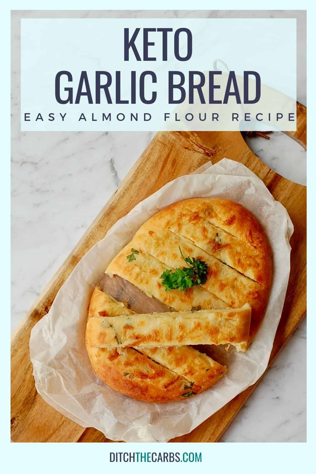 cheesy keto garlic bread sliced on baking parchment and a bread board
