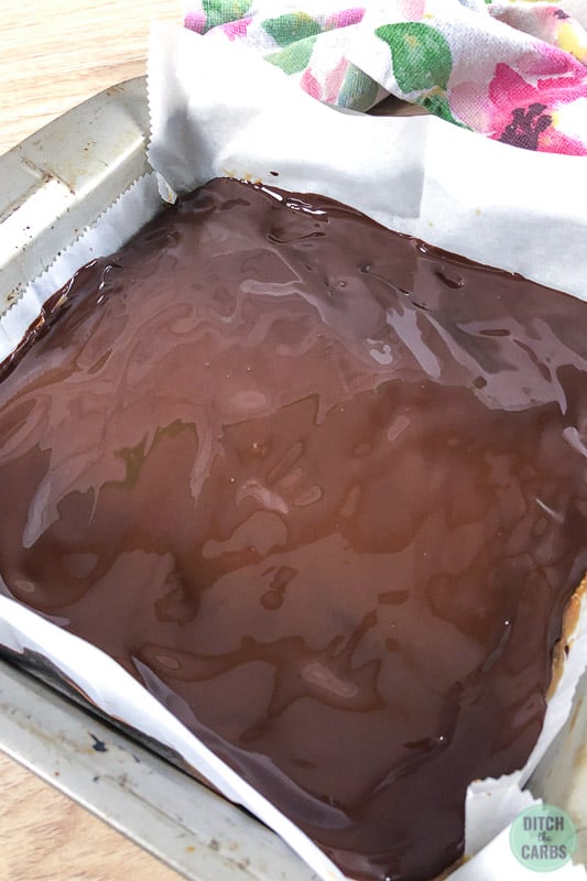 Melted dark chocolate spread over the chilled caramel in the baking pan.