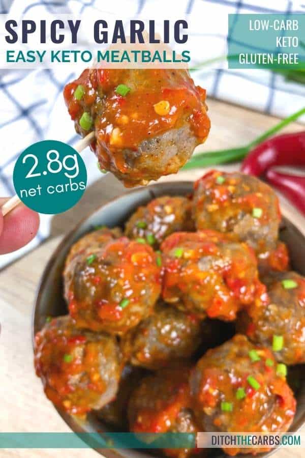 Spicy garlic keto meatball being served in a blue bowl. One meatball is being lifted with a toothpick.