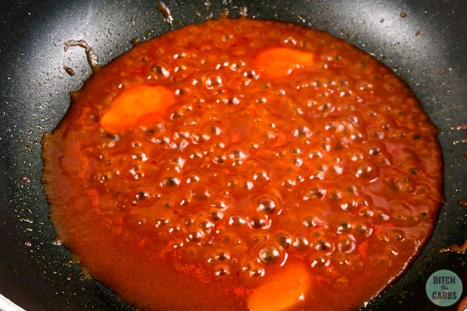 Sweet and sour sauce simmering in a skillet.