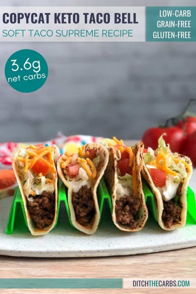 Four keto Taco Bell soft tacos on a white stone tray in a neon green taco holder.