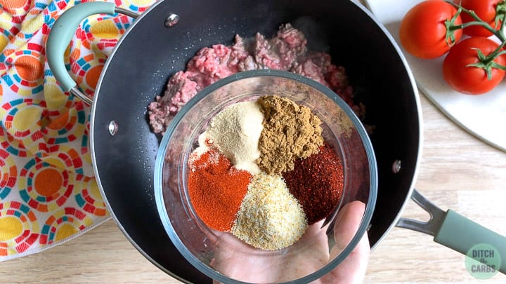All the spices for the keto Taco Bell meat is in a bowl about to be poured onto the ground been to make taco meat.
