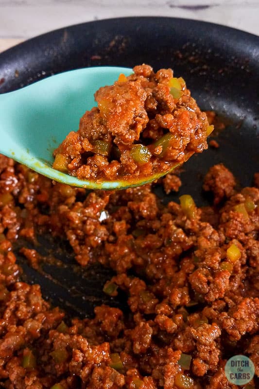Low-Carb Sloppy Joes in a skillet with a teal spoon