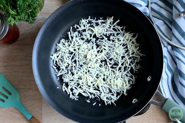 cheese sprinkled on a pan 