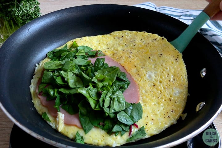 Keto Reverse Omelette  with ham and spinach before folding in half