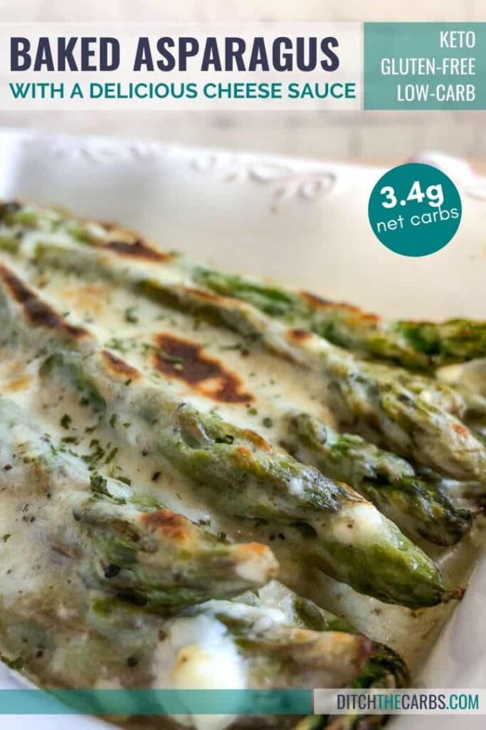 Close up show of keto cheesy baked asparagus in a white dish.