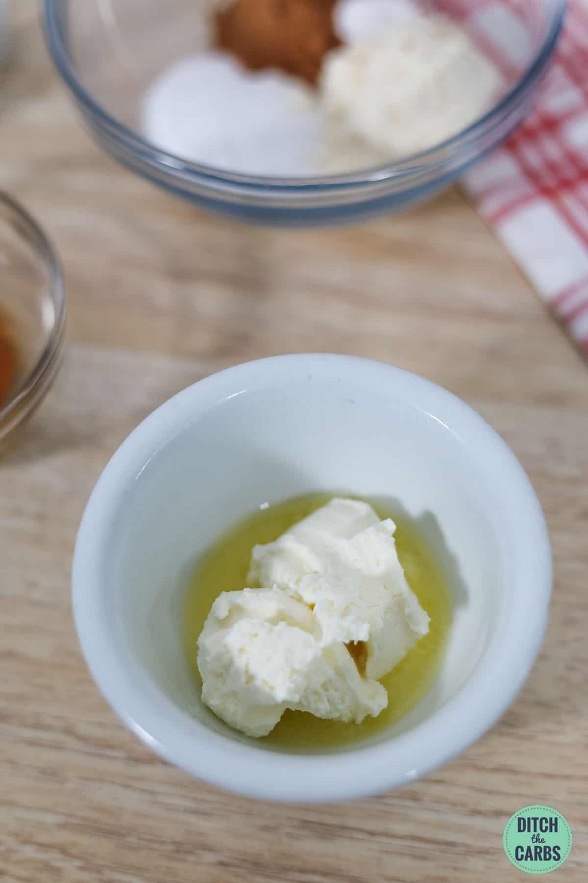 cream cheese and metled butter in a white mug