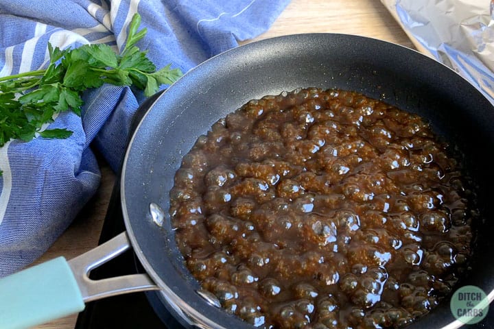 A frying pan with dark sauce