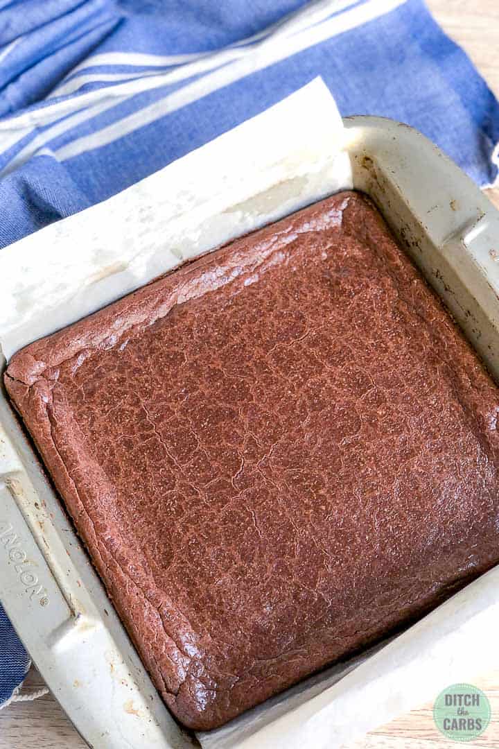 Baked keto dairy-free brownies in a metal square baking pan.