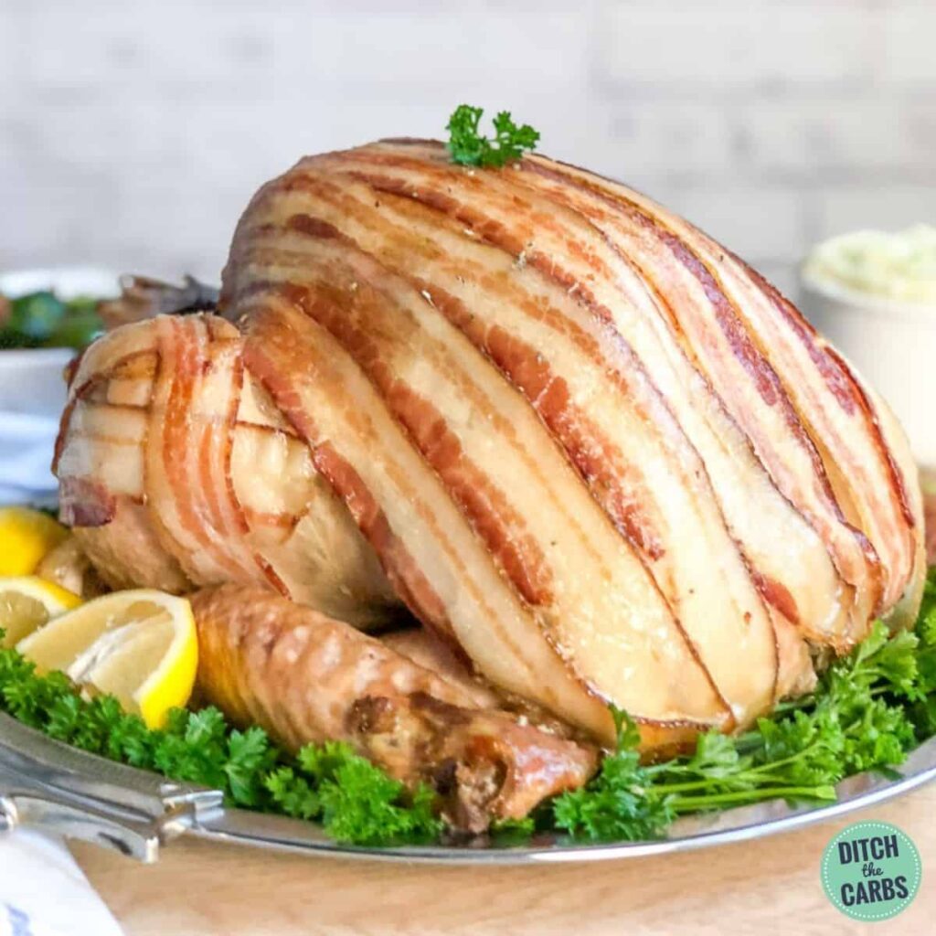 how to cook a roast turkey covered in bacon and served on a carving dish