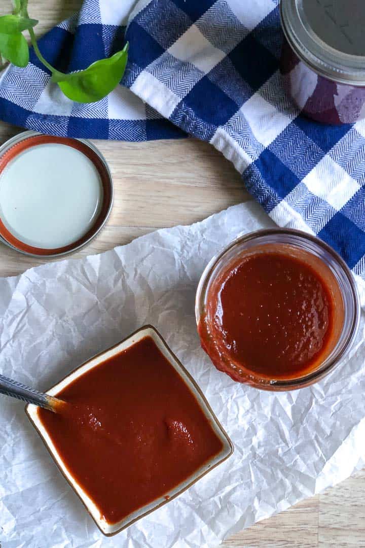 Overhead image of keto BBQ sauce poured into a small square dish for dipping and the jar of sauce set next to the dish on the right.