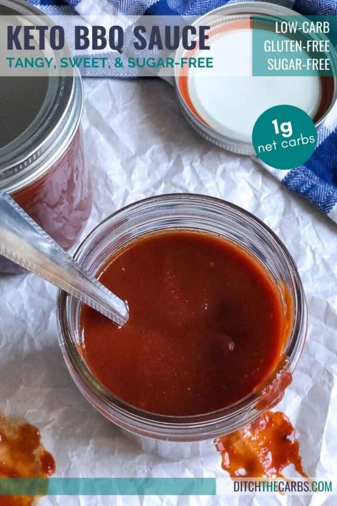 A jar of home-made sugarfree barbecue sauce dripping down the side with a spoon