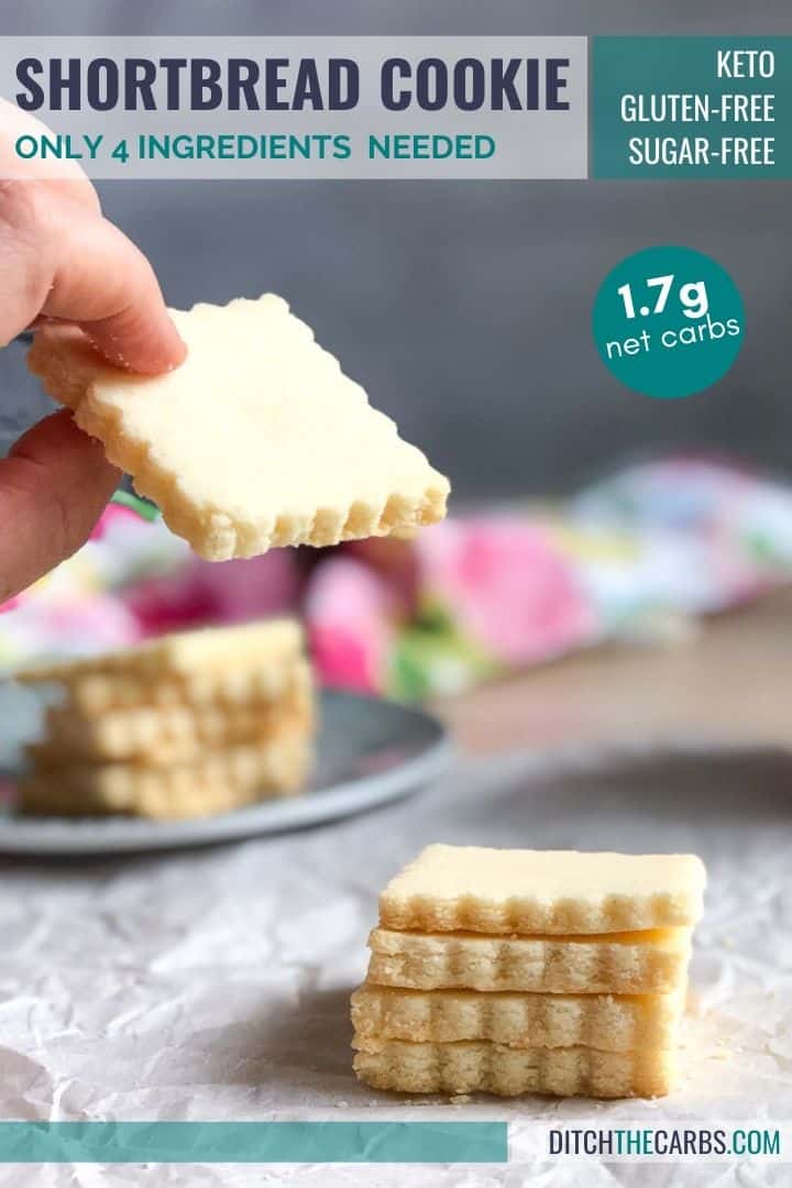 A hand is lifting a keto shortbread cookies off a plate stacked with more cookies.