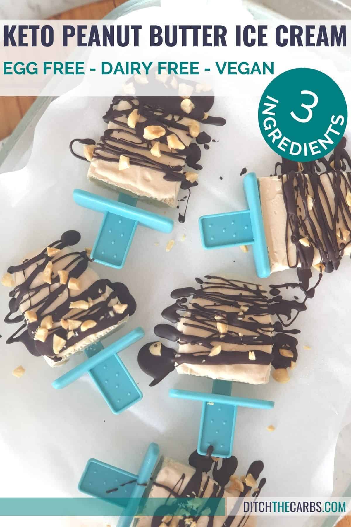 Keto peanut butter ice cream cubes sit on a glass plate and blue cloth
