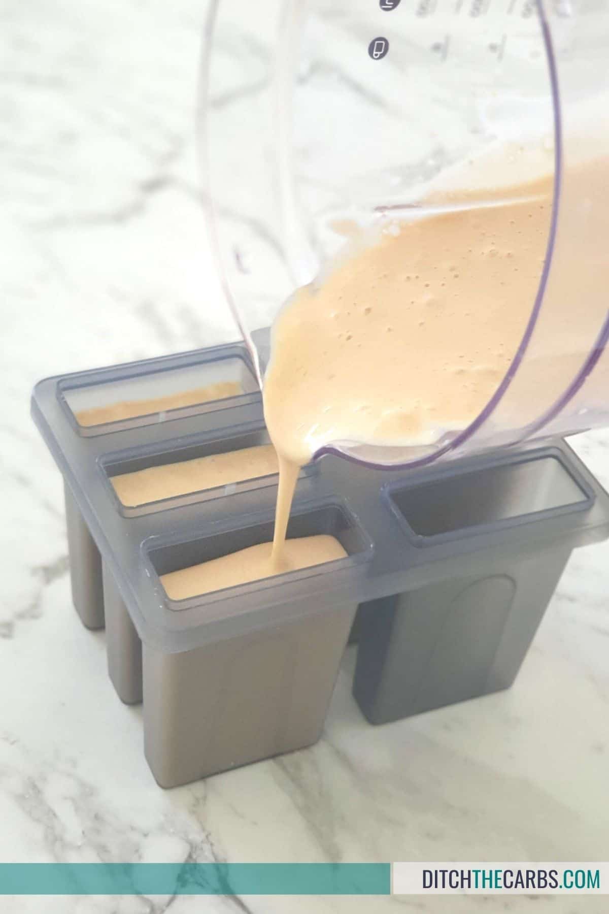 pouring ice cream into popsicle moulds to make keto peanut butter ice cream