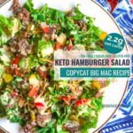 keto hamburger salad on a white plate and blue cloth