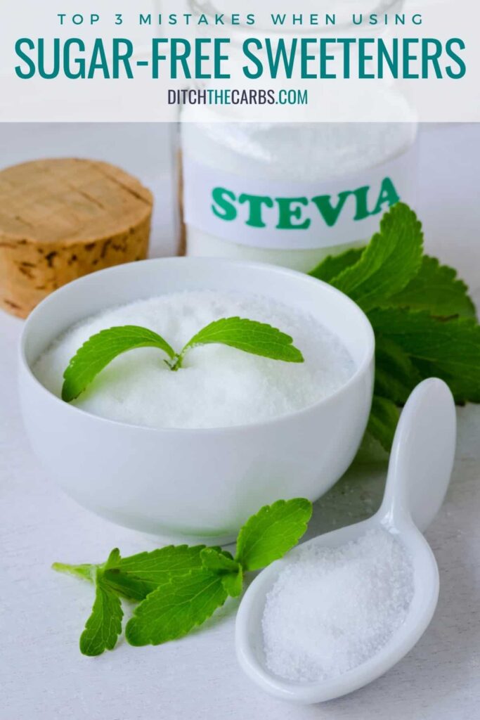 stevia in a bowl, with a measuring spoon and glass jar of stevia